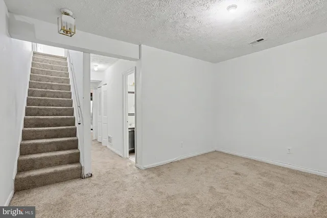 a view of an empty room and wooden floor
