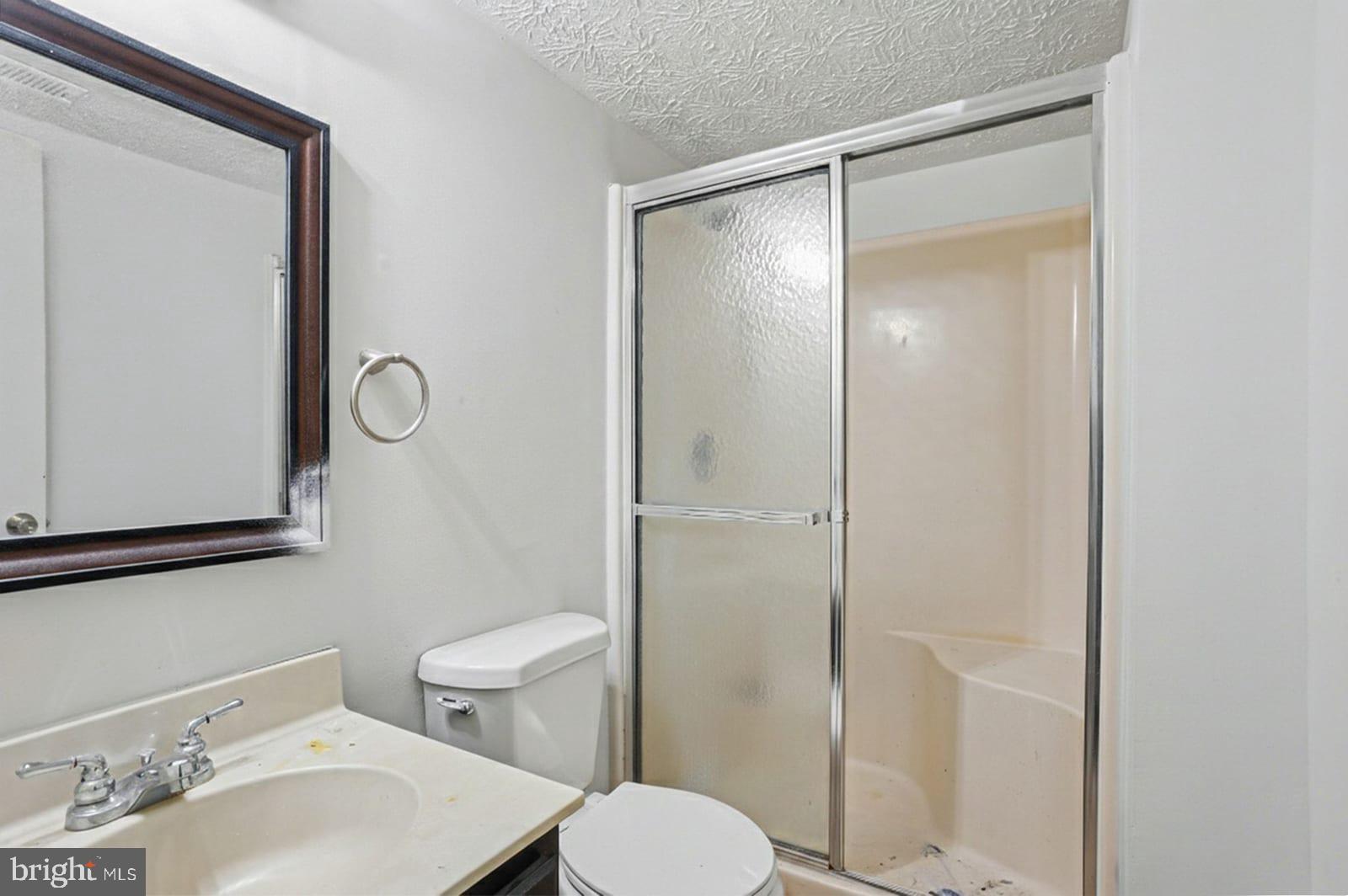 834 West Spring Meadow Court Edgewood, MD 21040 - Photo 19 of 25 a bathroom with a toilet sink vanity and shower