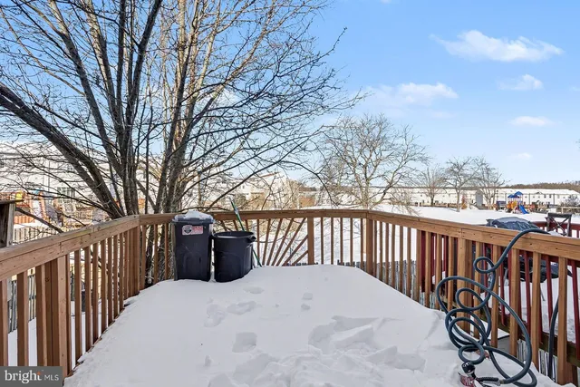 a view of roof deck with wooden fence and floor