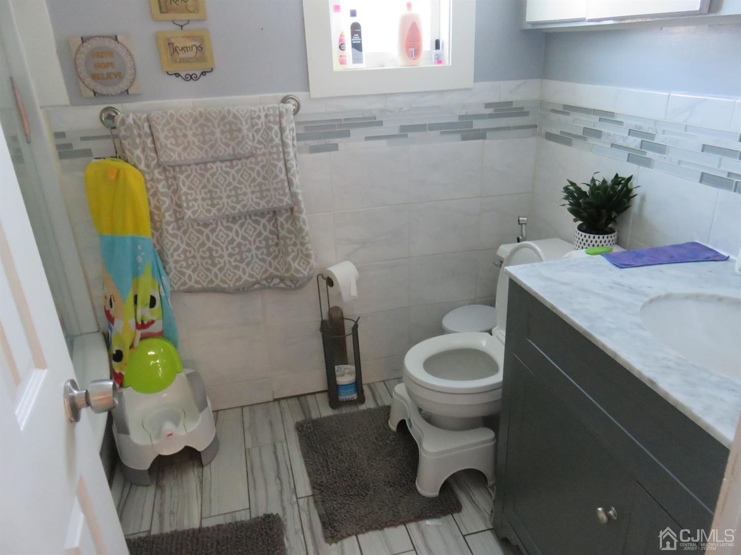 268 Rector Street Perth Amboy, NJ 08861 - Photo 6 of 13 a bathroom with a sink and toilet