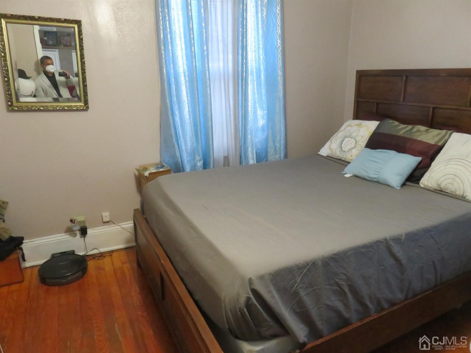 268 Rector Street Perth Amboy, NJ 08861 - Photo 9 of 13 a bedroom with a bed and a painting on the wall