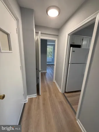 hallway with wooden floor and stairs