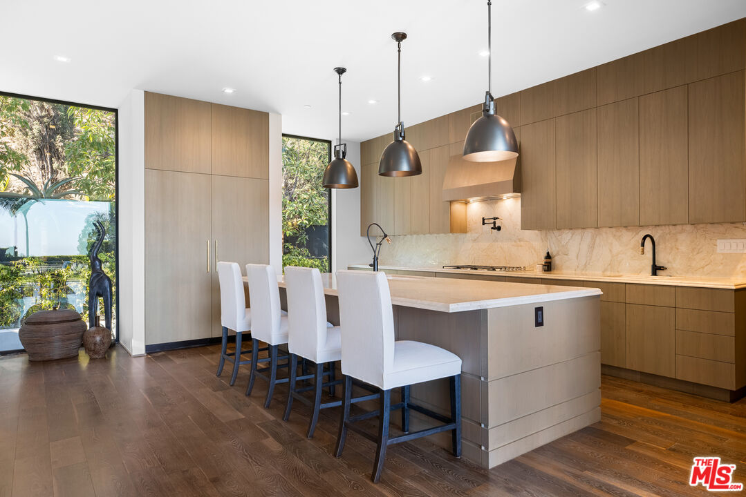1717 Rising Glen Road Los Angeles, CA 90069 - Photo 14 of 30 a kitchen with a table chairs sink and wooden floor