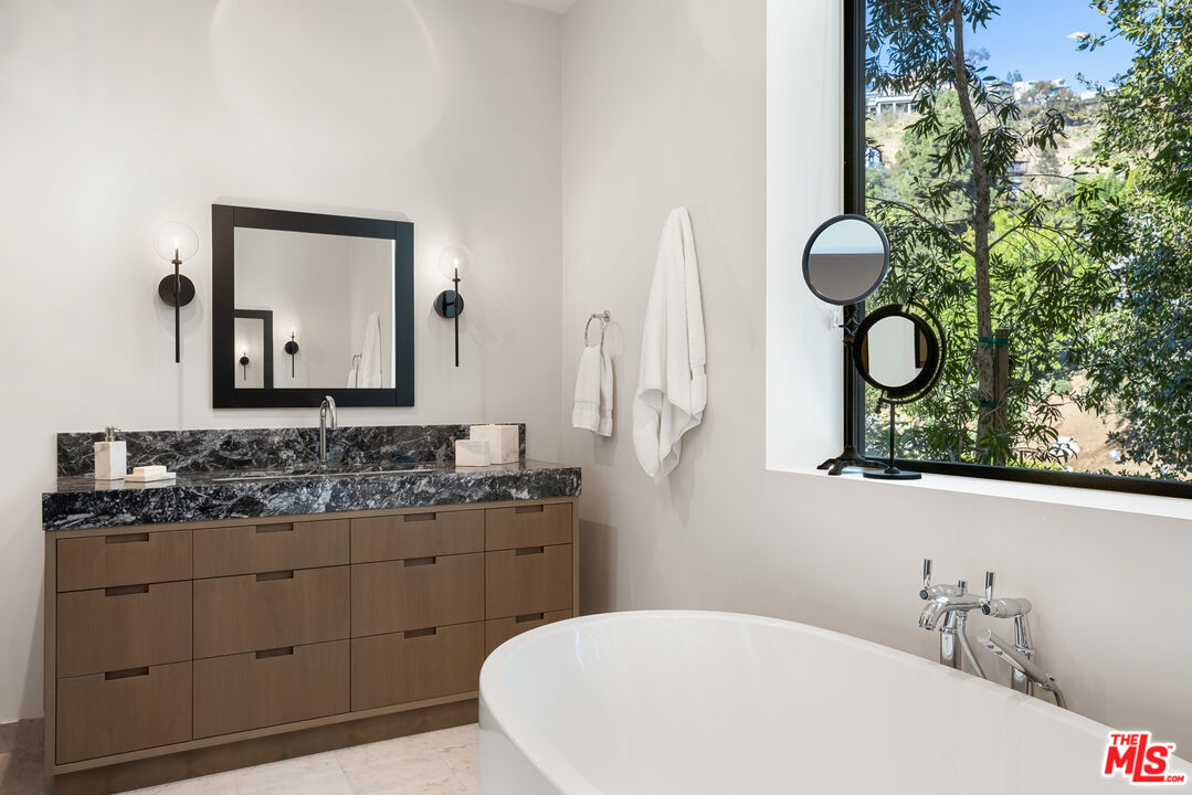 1717 Rising Glen Road Los Angeles, CA 90069 - Photo 23 of 30 a bathroom with a sink and a mirror
