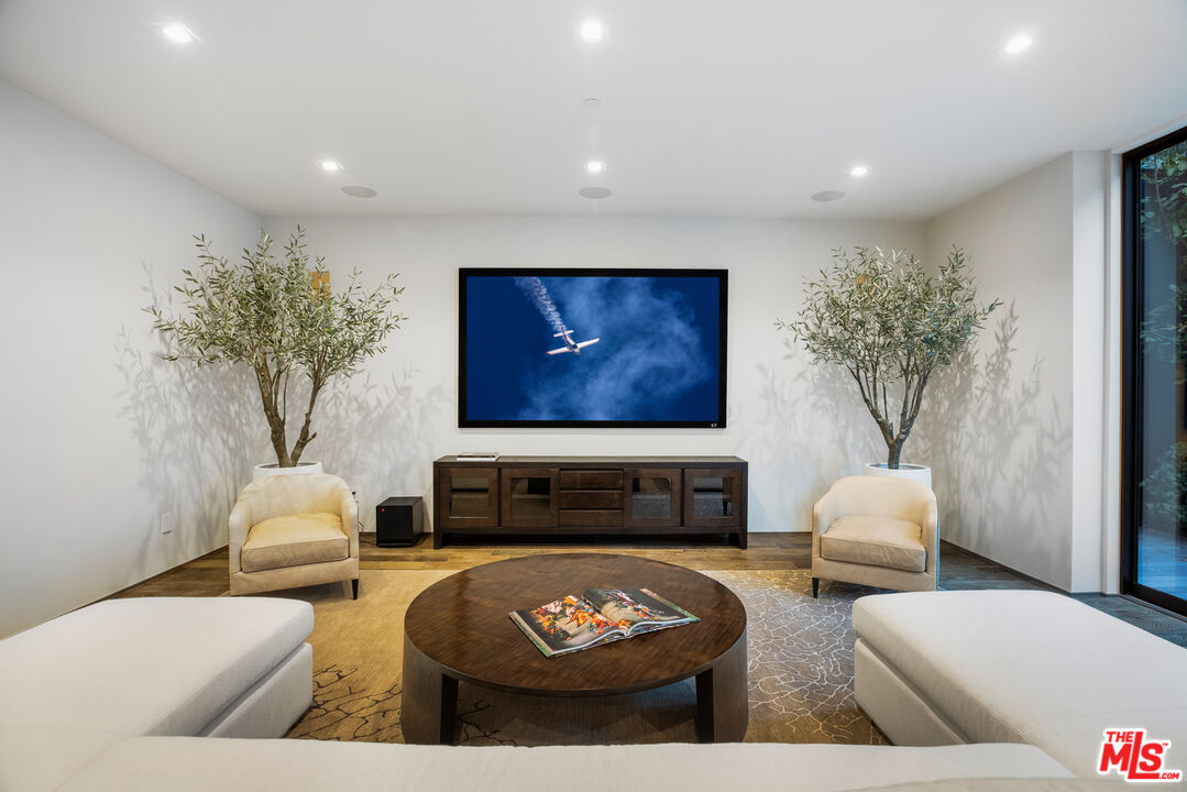 1717 Rising Glen Road Los Angeles, CA 90069 - Photo 27 of 30 a living room with furniture and a potted plant