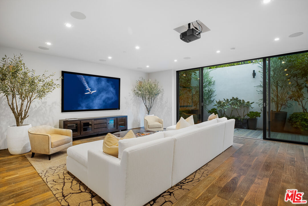 1717 Rising Glen Road Los Angeles, CA 90069 - Photo 28 of 30 a living room with furniture and a flat screen tv