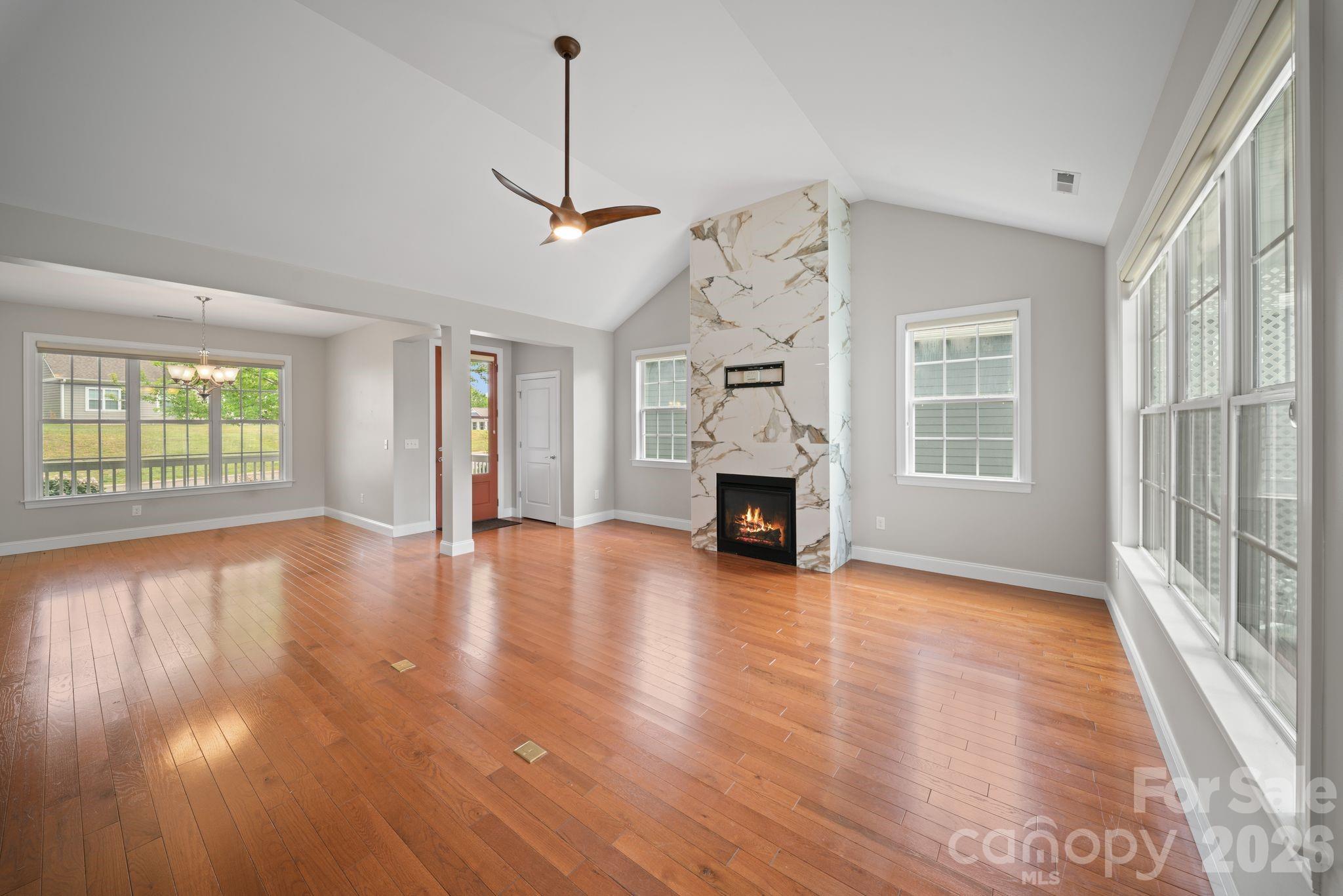 14 Rose Creek Road Leicester, NC 28748 - Photo 11 of 42 a view of empty room with wooden floor and fireplace