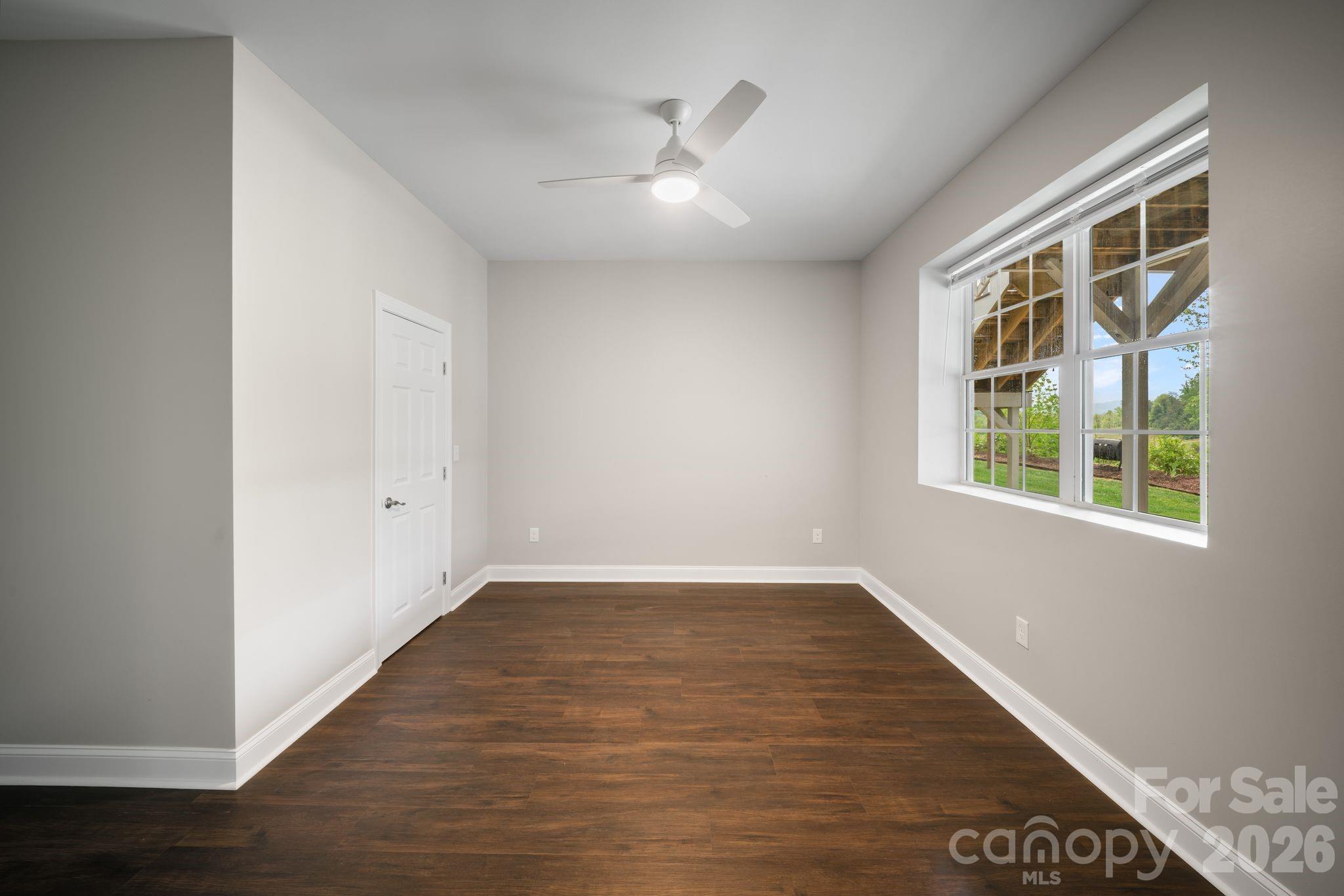 14 Rose Creek Road Leicester, NC 28748 - Photo 30 of 42 a view of an empty room with wooden floor and a window