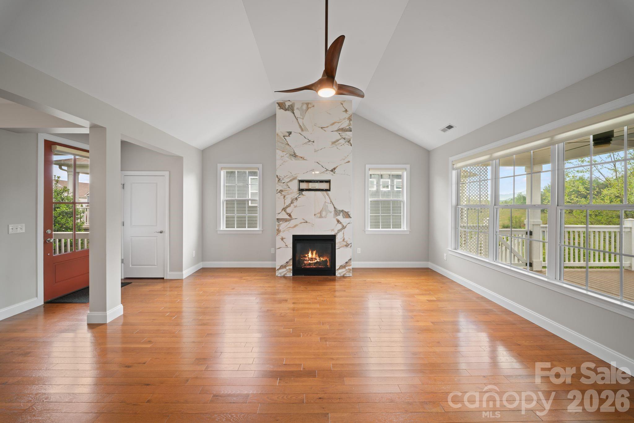 14 Rose Creek Road Leicester, NC 28748 - Photo 10 of 42 a view of an empty room with a fireplace and a window