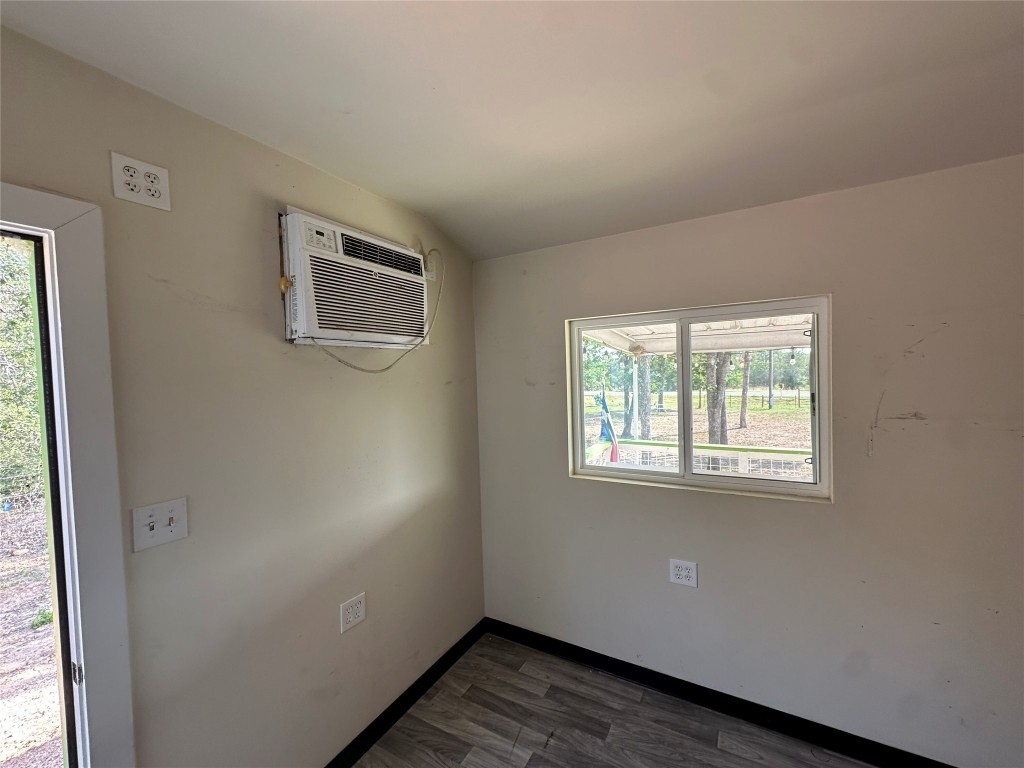 10096 Highway 183 Lockhart, TX 78644 - Photo 13 of 16 a view of an empty room with wooden floor and a window