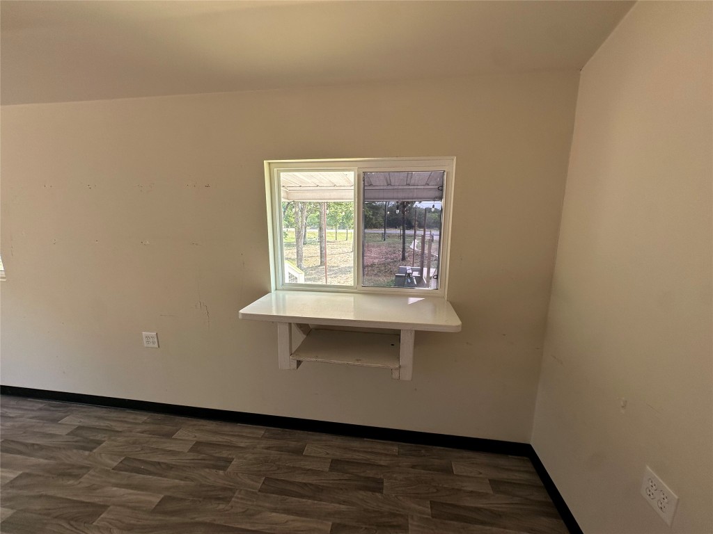 10096 Highway 183 Lockhart, TX 78644 - Photo 15 of 16 an empty room with wooden floor and cabinet
