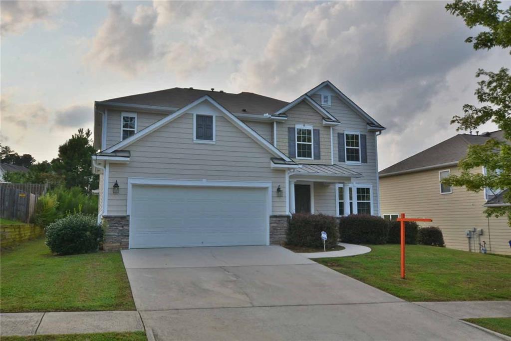 2068 Cutleaf Creek Road Southeast Grayson, GA 30017 - Photo 1 of 1 a front view of a house with a yard and garage