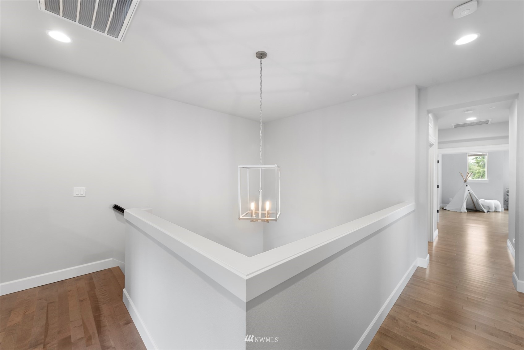23214 7th Drive Southeast Bothell, WA 98021 - Photo 20 of 37 a hallway with chandelier and wooden floor