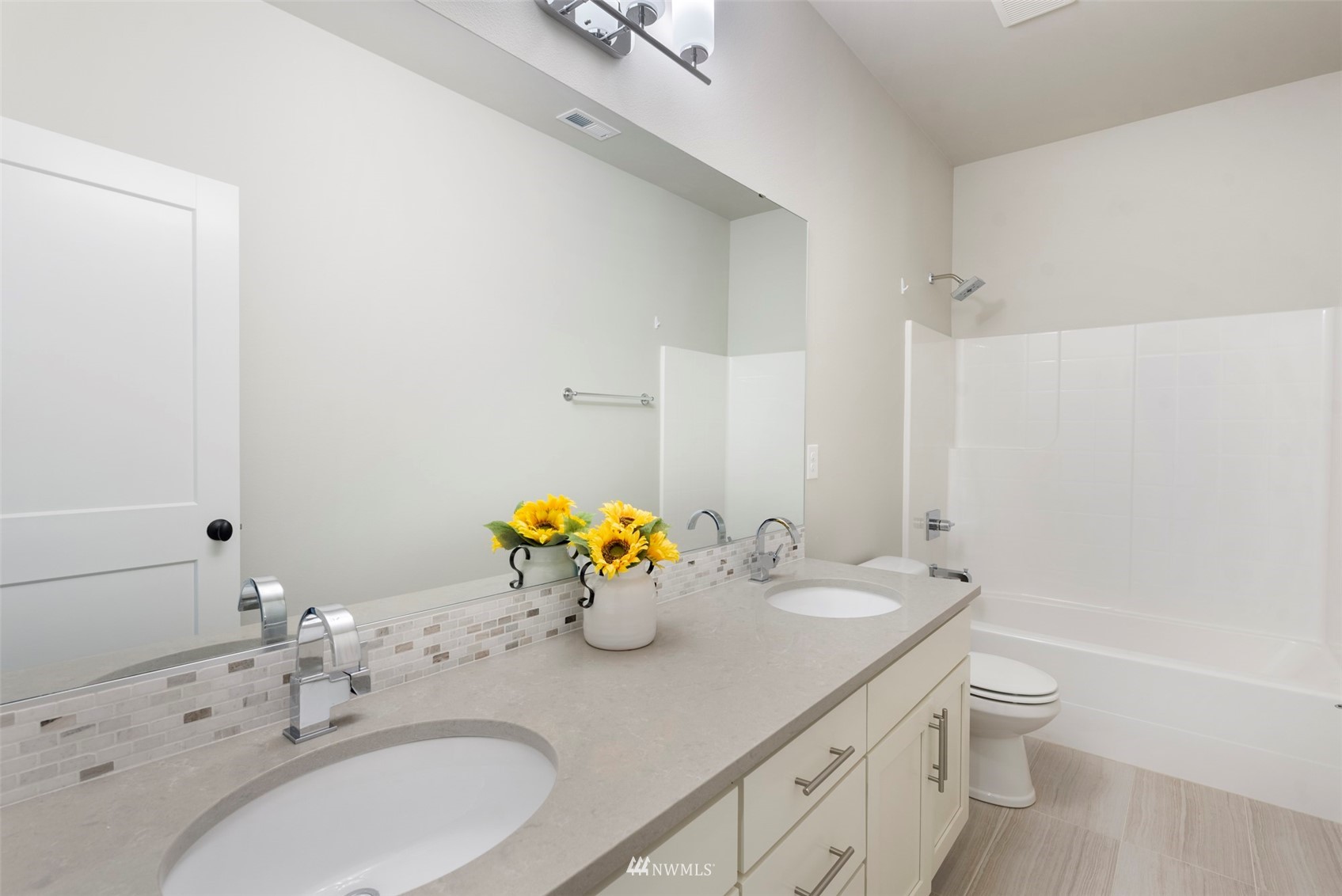 23214 7th Drive Southeast Bothell, WA 98021 - Photo 31 of 37 a bathroom with a granite countertop sink a toilet and a large mirror
