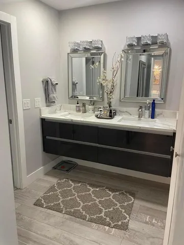 a bathroom with a double vanity sink and a mirror