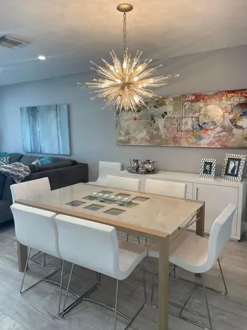 a dining room with furniture and chandelier