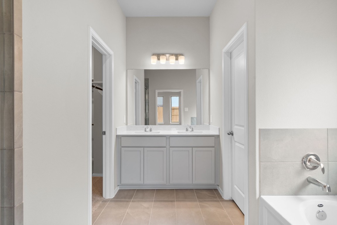 9515 Sierra Crest Lane Porter, TX 77365 - Photo 16 of 38 a bathroom with a tub sink and mirror