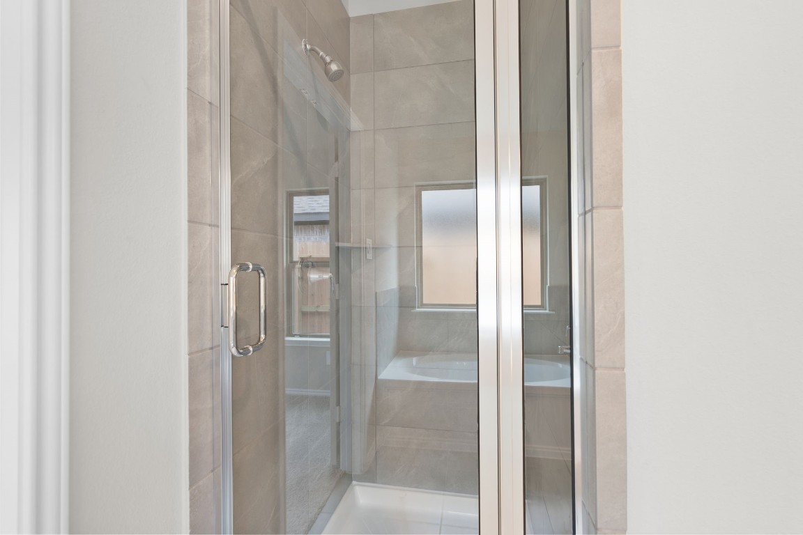 9515 Sierra Crest Lane Porter, TX 77365 - Photo 17 of 38 a bathroom with a glass shower door
