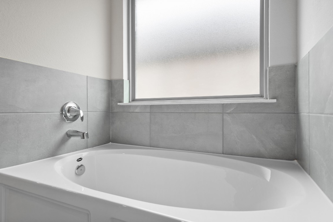 9515 Sierra Crest Lane Porter, TX 77365 - Photo 18 of 38 a white bath tub sitting in a bathroom
