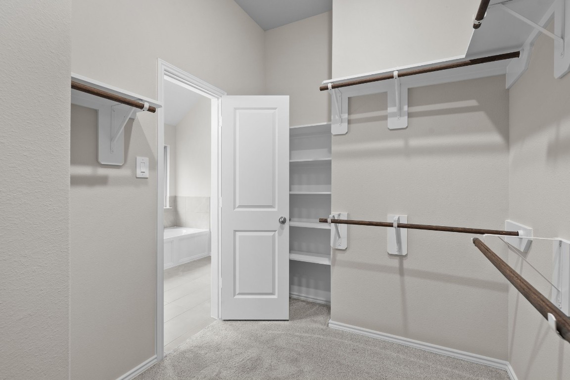 9515 Sierra Crest Lane Porter, TX 77365 - Photo 19 of 38 a view of walk in closet with empty racks