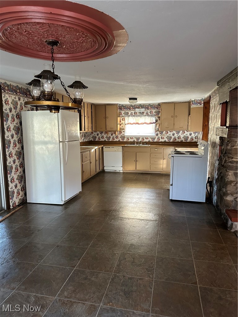 44952 Moose Ridge Road Woodsfield, OH 43793 - Photo 24 of 48 Kitchen with refrigerator, stove, wallpapered walls, white dishwasher, and dark countertops