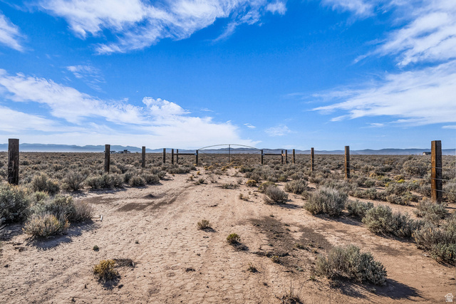 3825 West 5200th Road North Beryl, UT 84714 - Photo 7 of 10 View of yard featuring view of desert landscape and a mountain view