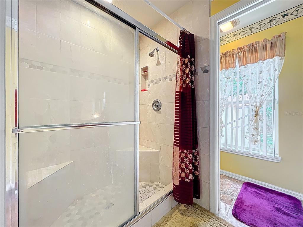7939 Riffle Lane Orlando, FL 32818 - Photo 29 of 52 a bathroom with a bathtub and shower