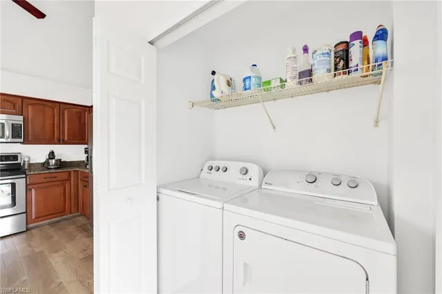 a utility room with sink dryer and washer
