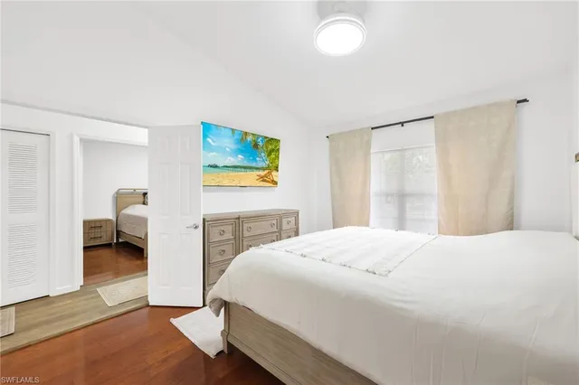 a bedroom with a bed and a painting on the wall