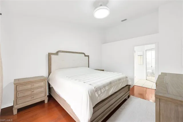 a bedroom with a bed and cabinet