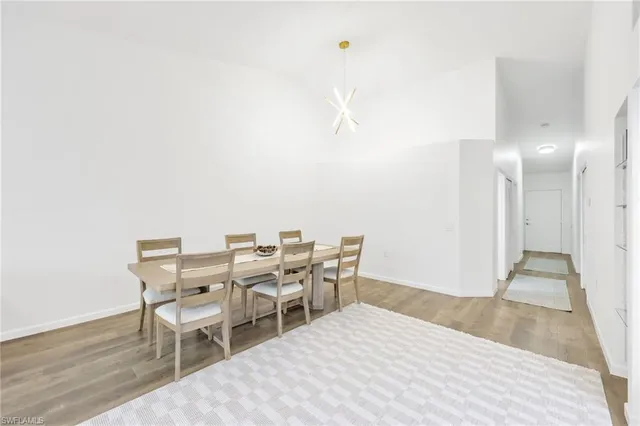 a view of a bedroom with furniture and wooden floor