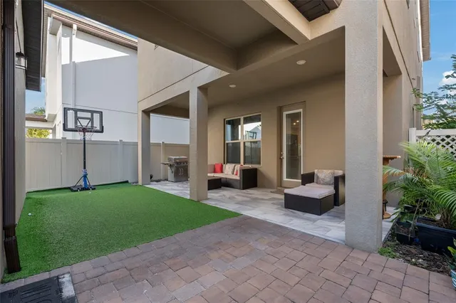 a view of a house with backyard sitting area and garden