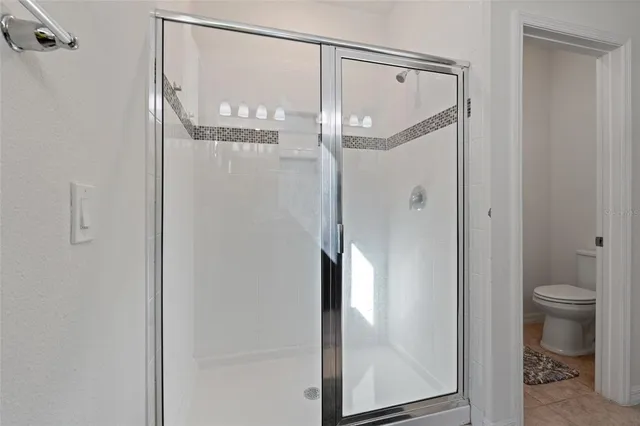 a bathroom with a glass shower door