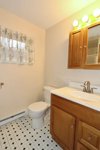 a view of a room with wooden floor chandelier and a ceiling fan