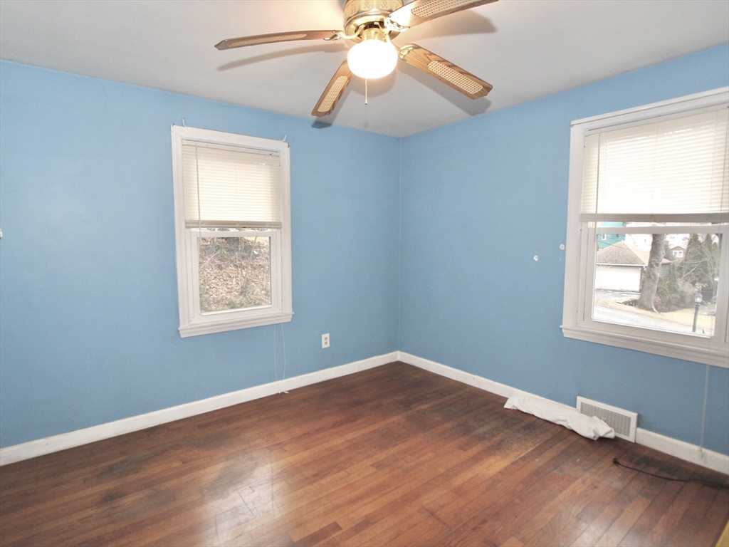 6 Roald Street Worcester, MA 01605 - Photo 9 of 11 an empty room with wooden floor fan and windows