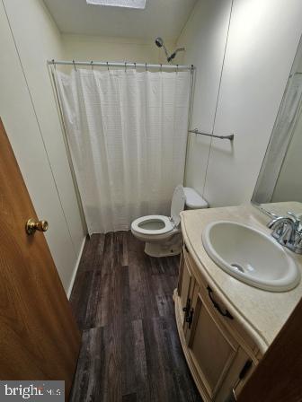 2110 Mays Landing Road, Unit WALL Millville, NJ 08332 - Photo 13 of 18 a bathroom with a sink a toilet a mirror and shower curtain