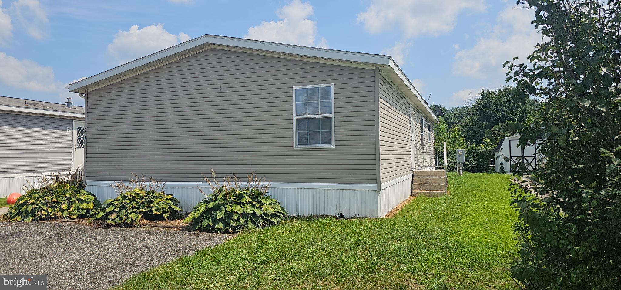 2110 Mays Landing Road, Unit WALL Millville, NJ 08332 - Photo 3 of 18 a front view of a house with a garden