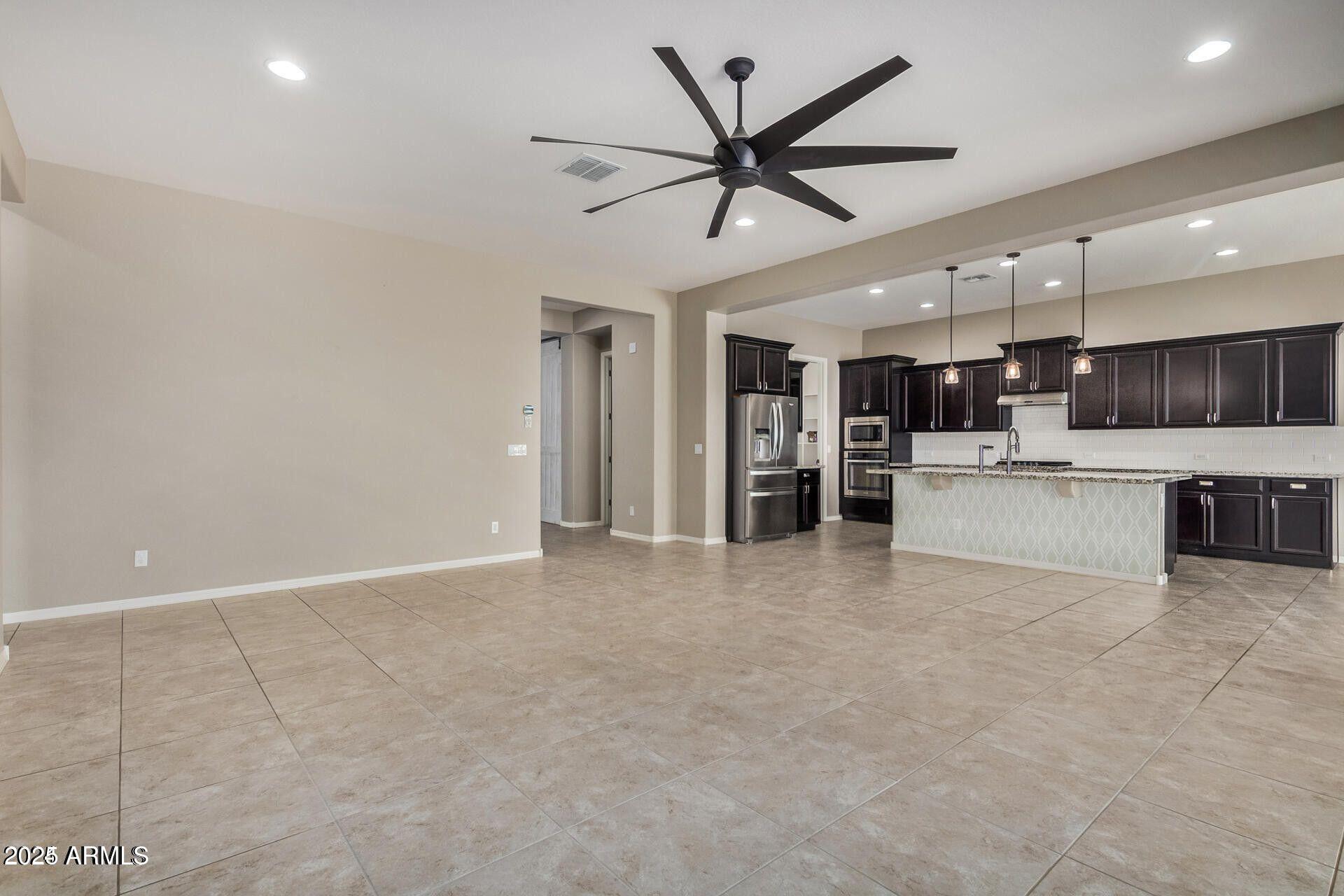 15430 South 183rd Lane Goodyear, AZ 85338 - Photo 12 of 66 a view of a kitchen with a sink and a refrigerator