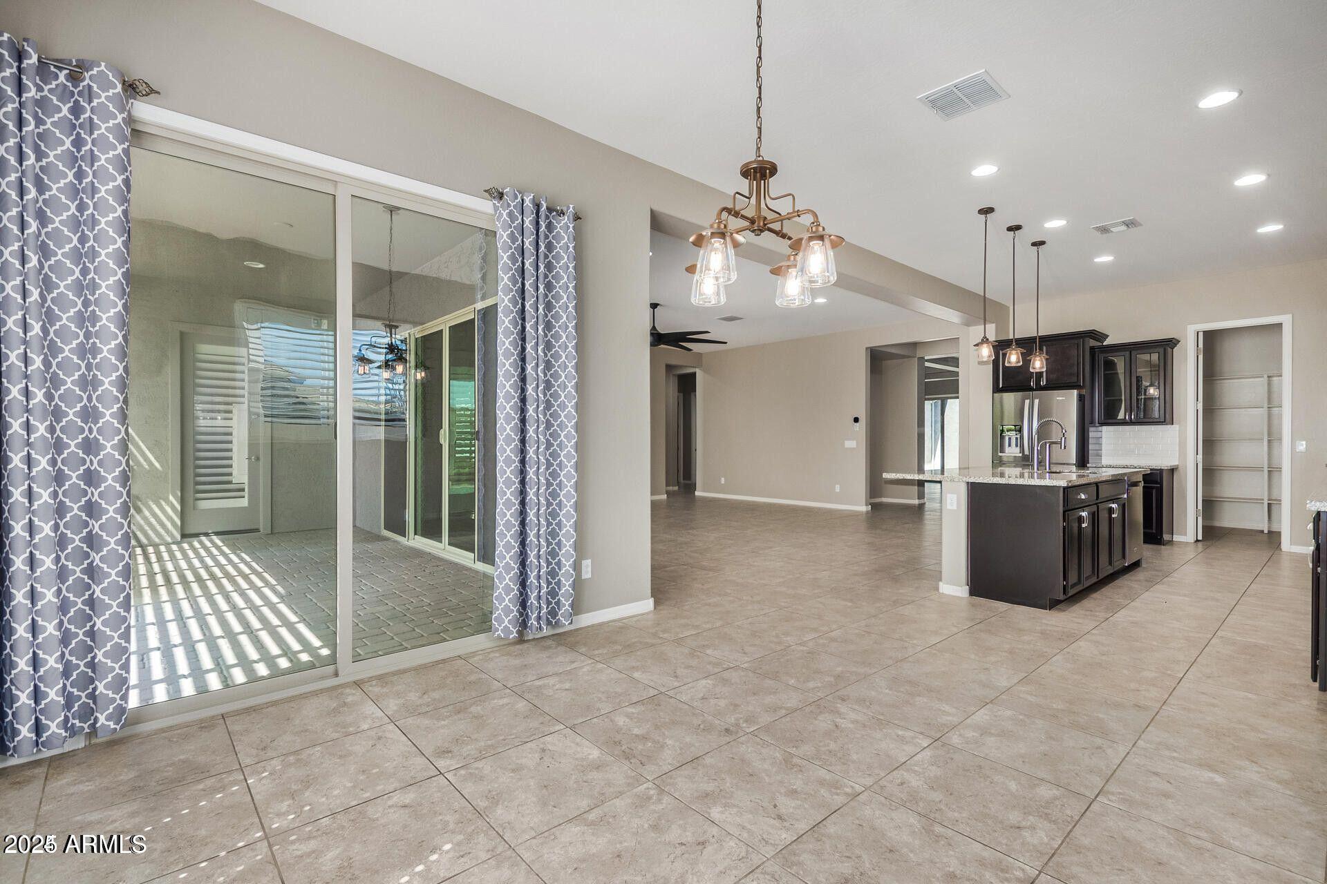 15430 South 183rd Lane Goodyear, AZ 85338 - Photo 17 of 66 a view of a kitchen with a sink and a refrigerator