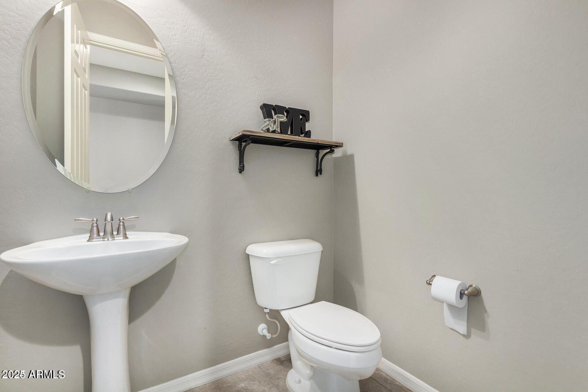 15430 South 183rd Lane Goodyear, AZ 85338 - Photo 19 of 66 a bathroom with a toilet sink and mirror