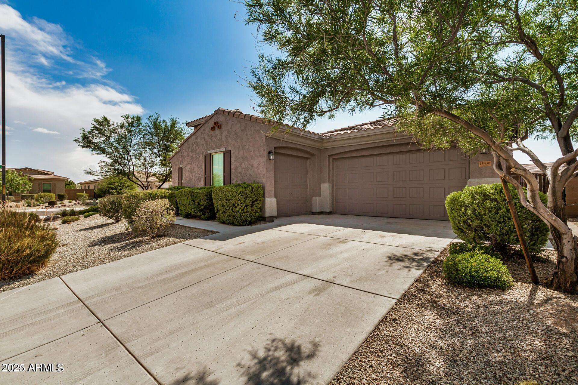 15430 South 183rd Lane Goodyear, AZ 85338 - Photo 2 of 66 a front view of a house with garden