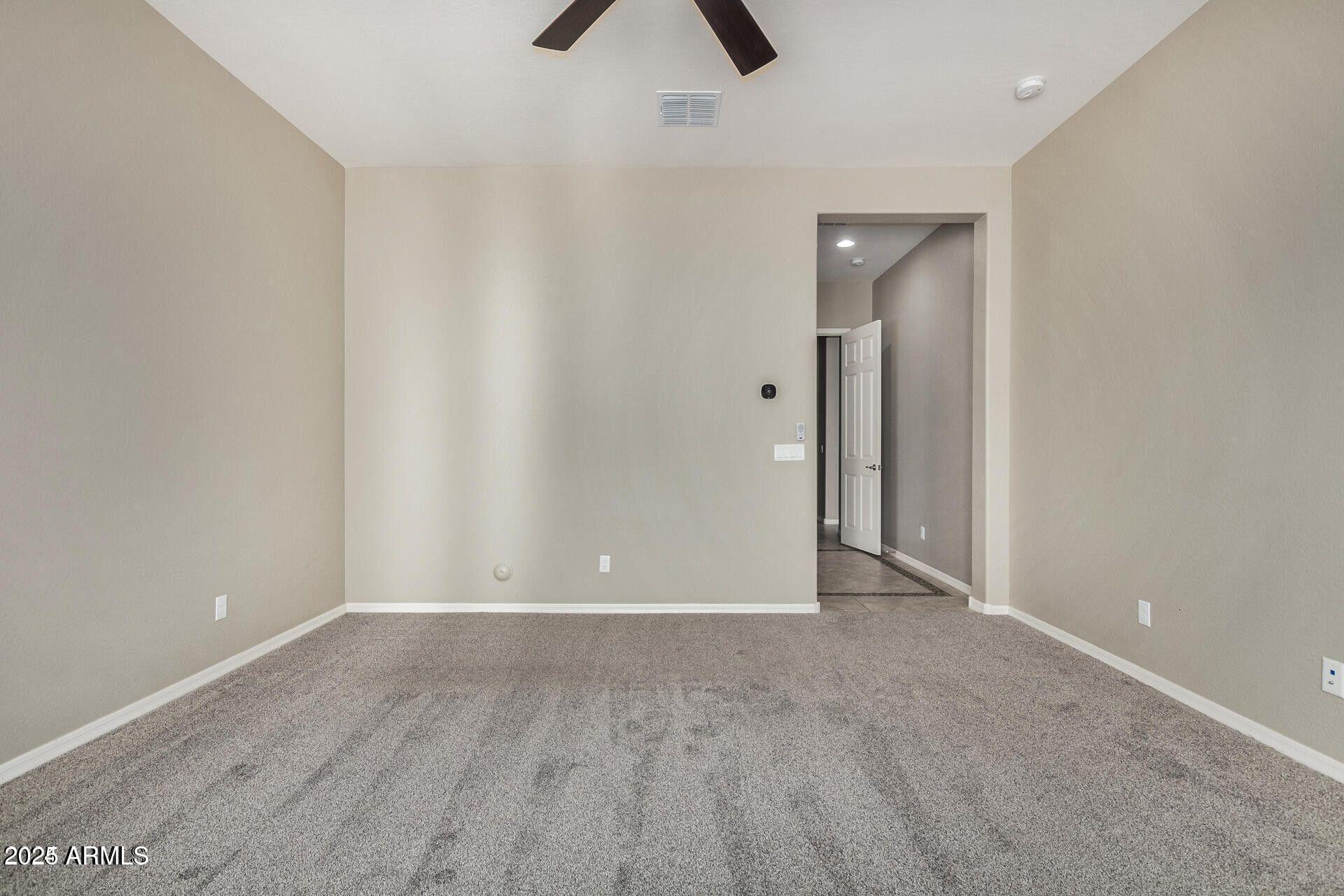 15430 South 183rd Lane Goodyear, AZ 85338 - Photo 21 of 66 an empty room with closet and chandelier fan