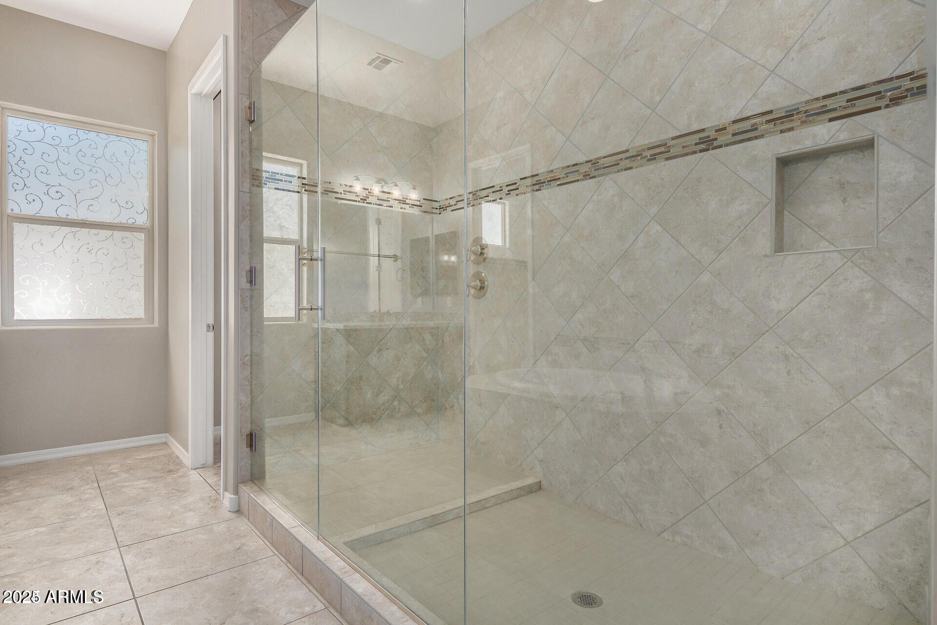 15430 South 183rd Lane Goodyear, AZ 85338 - Photo 24 of 66 a bathroom with a glass shower door