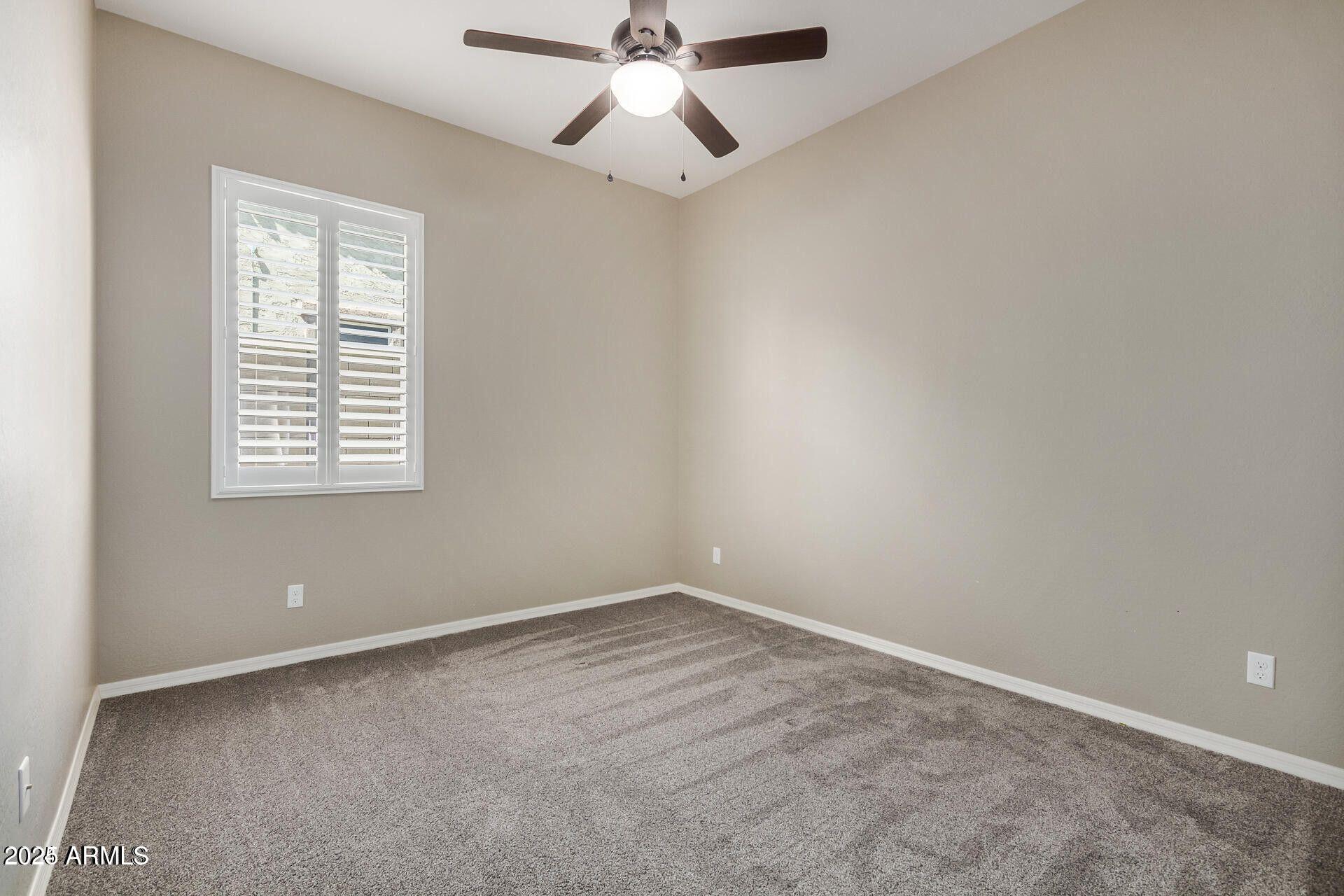 15430 South 183rd Lane Goodyear, AZ 85338 - Photo 27 of 66 an empty room with a window and a fan