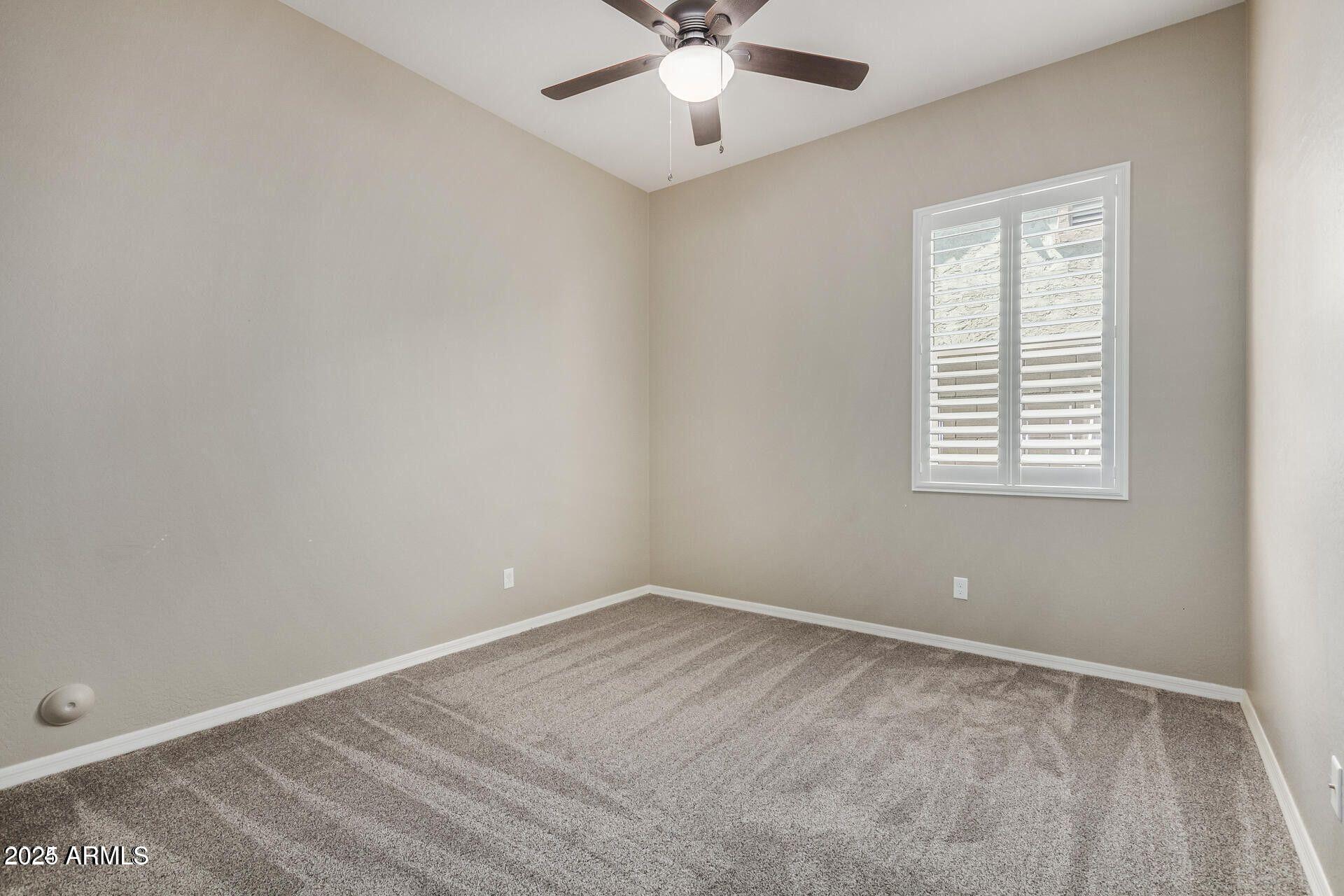 15430 South 183rd Lane Goodyear, AZ 85338 - Photo 28 of 66 an empty room with a window and a fan