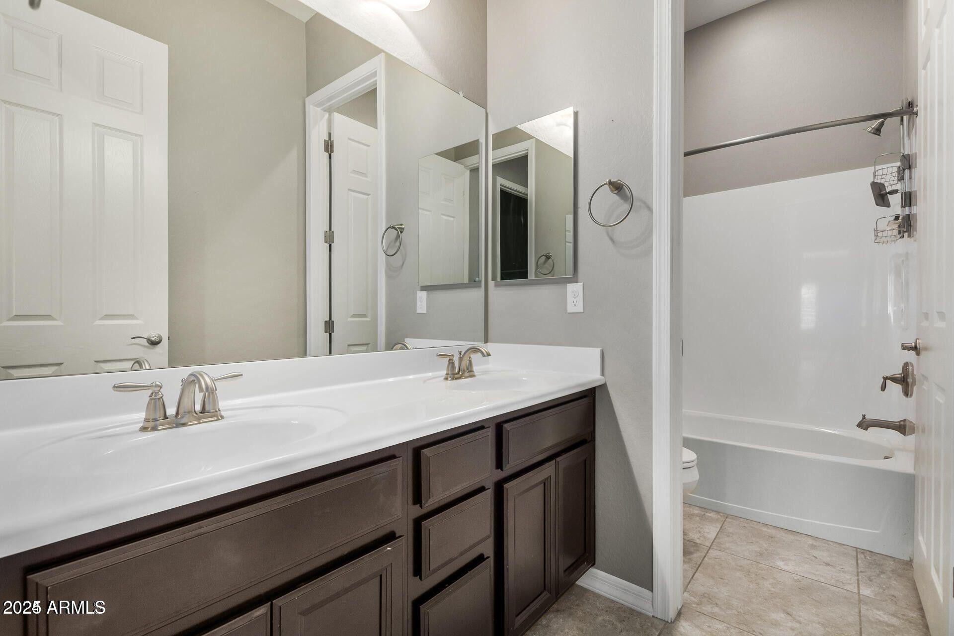 15430 South 183rd Lane Goodyear, AZ 85338 - Photo 30 of 66 a bathroom with a sink and a mirror