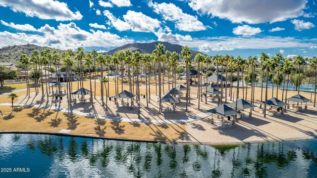 a front view of a swimming pool with a table and chairs