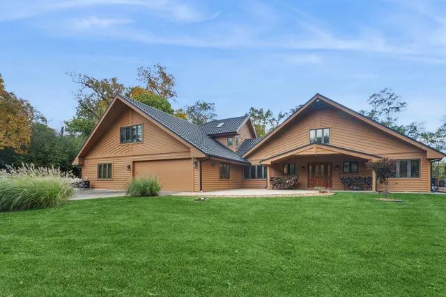 a view of a house with a big yard and potted plants