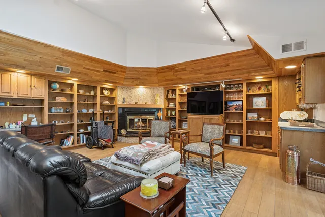 a bedroom with a large bed and windows