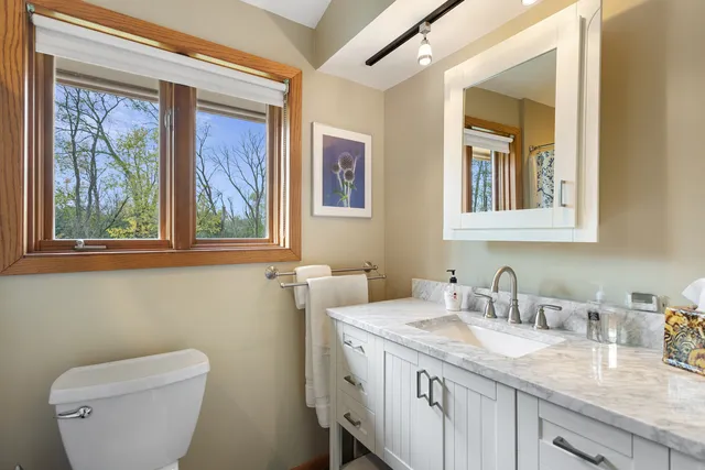 a view of a hallway with wooden floor and furniture